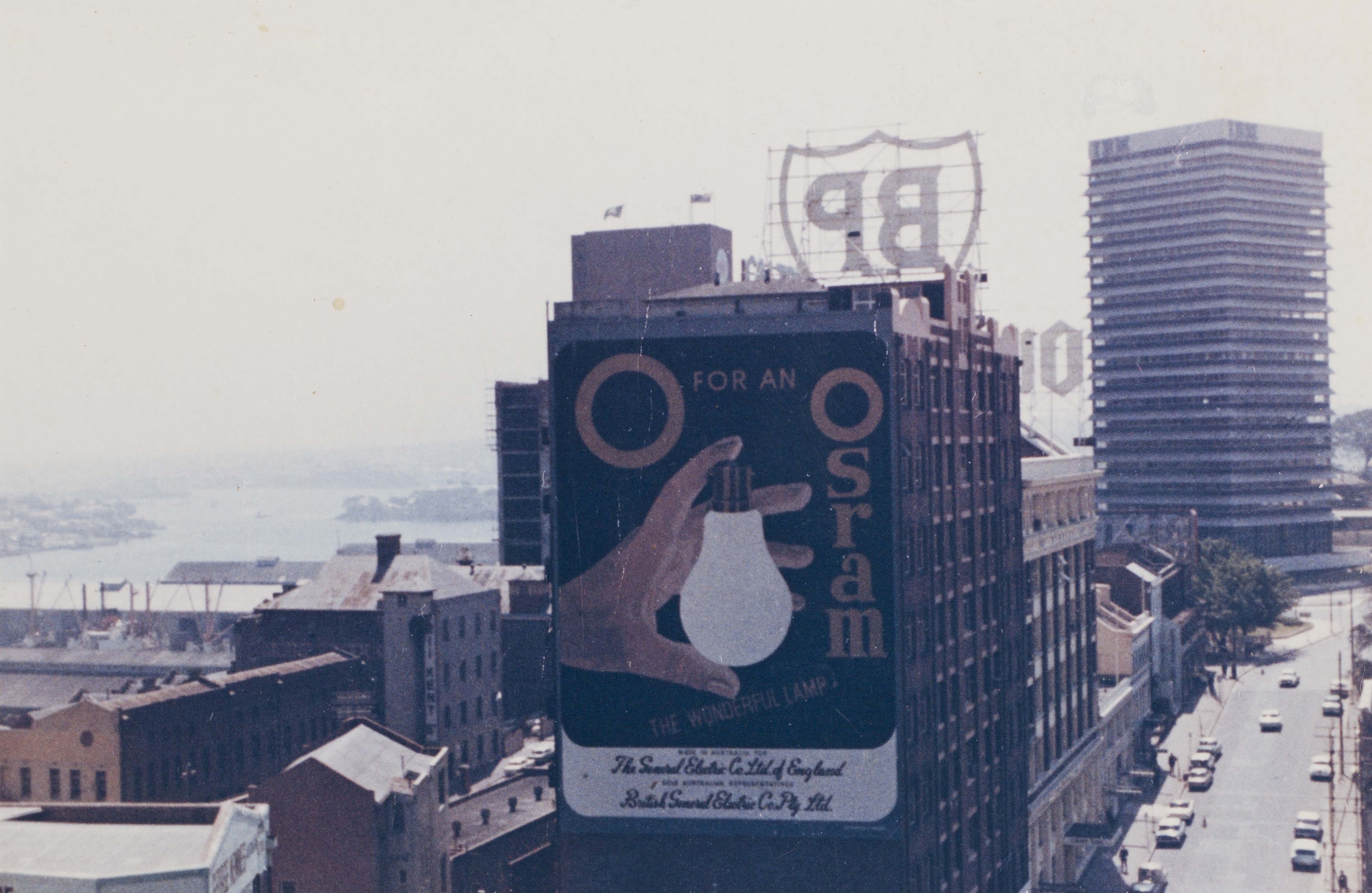 Large sign on building in middle of city