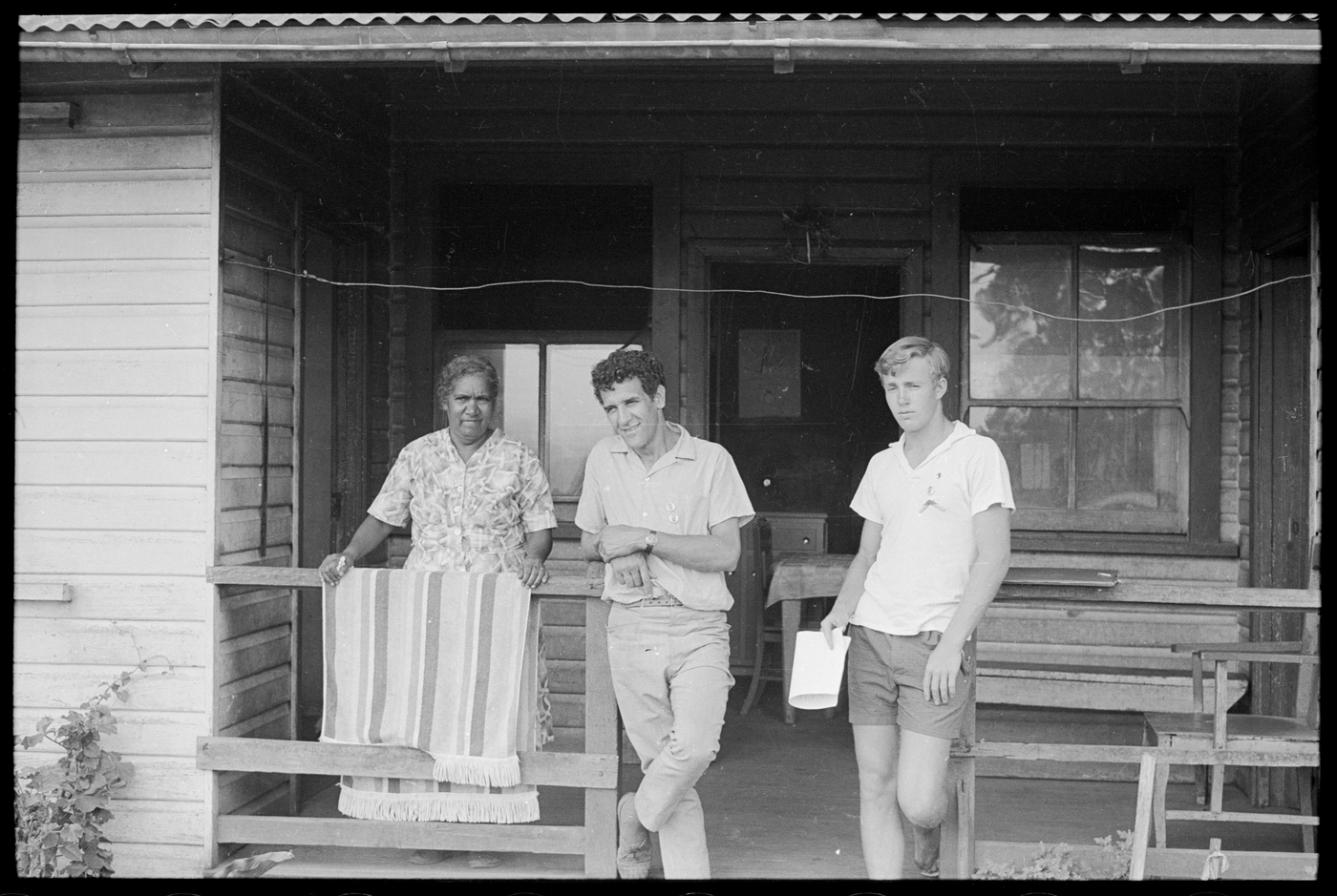 three people on a wood verandah