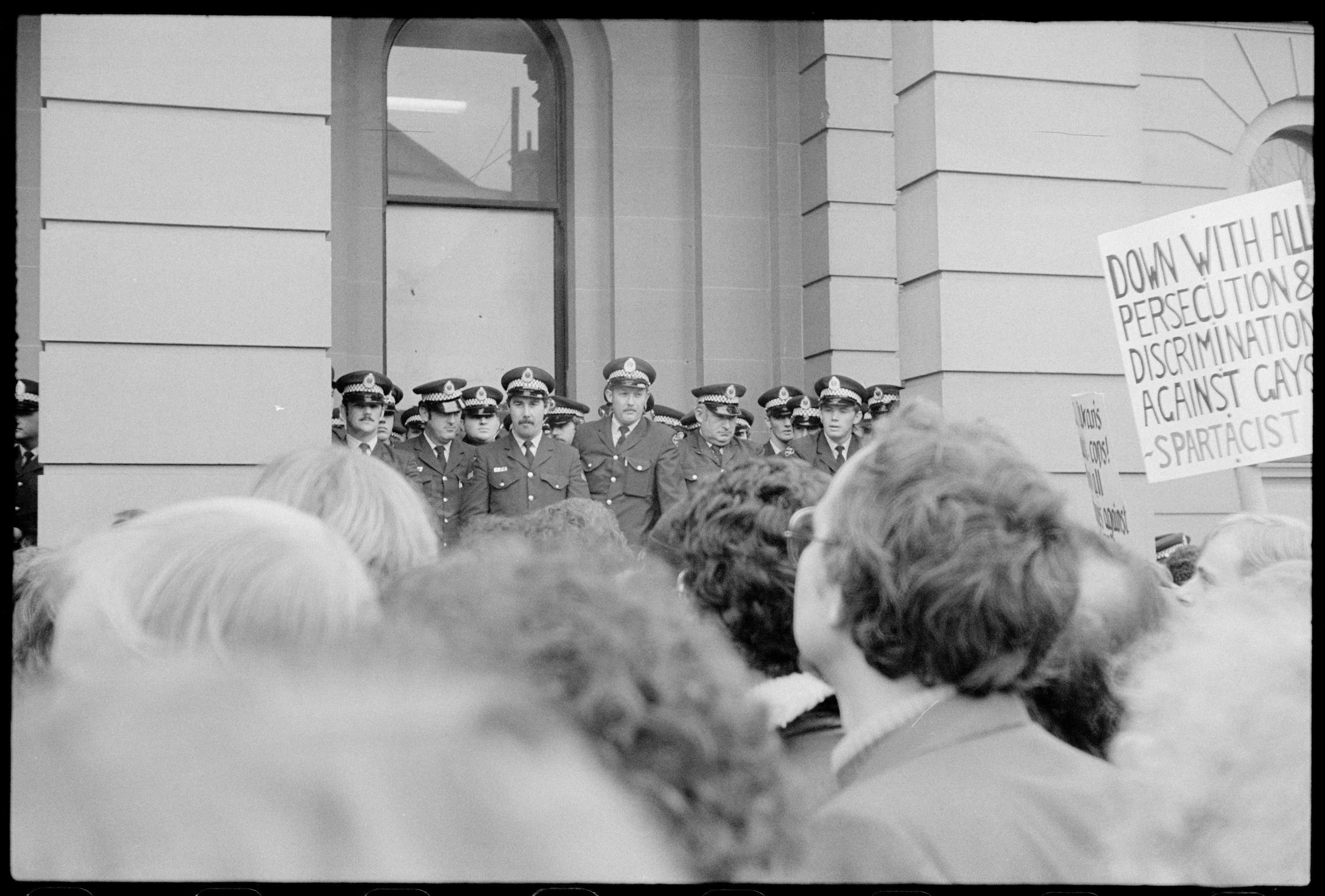 Placard: 'Down With All Persecution & Discrimination Against Gays - Spartacist', Gay Rights demonstration outside Central Police Court, Liverpool St, Sydney. Tribune Collection. NB: neg flipped