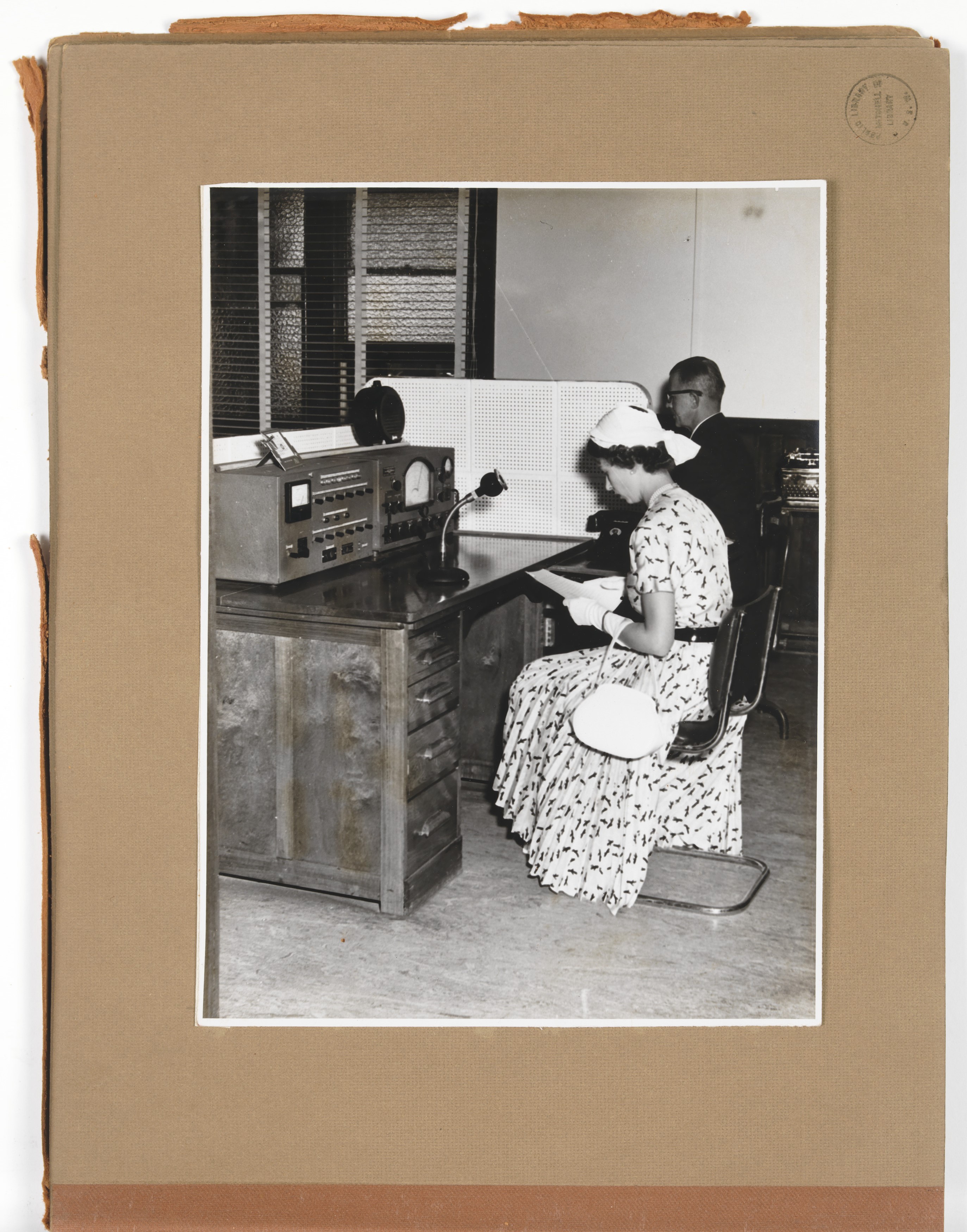 Photograph of Her Majesty Queen Elizabeth making a broadcast over The Flying Doctor network at H.Q. Broken Hill