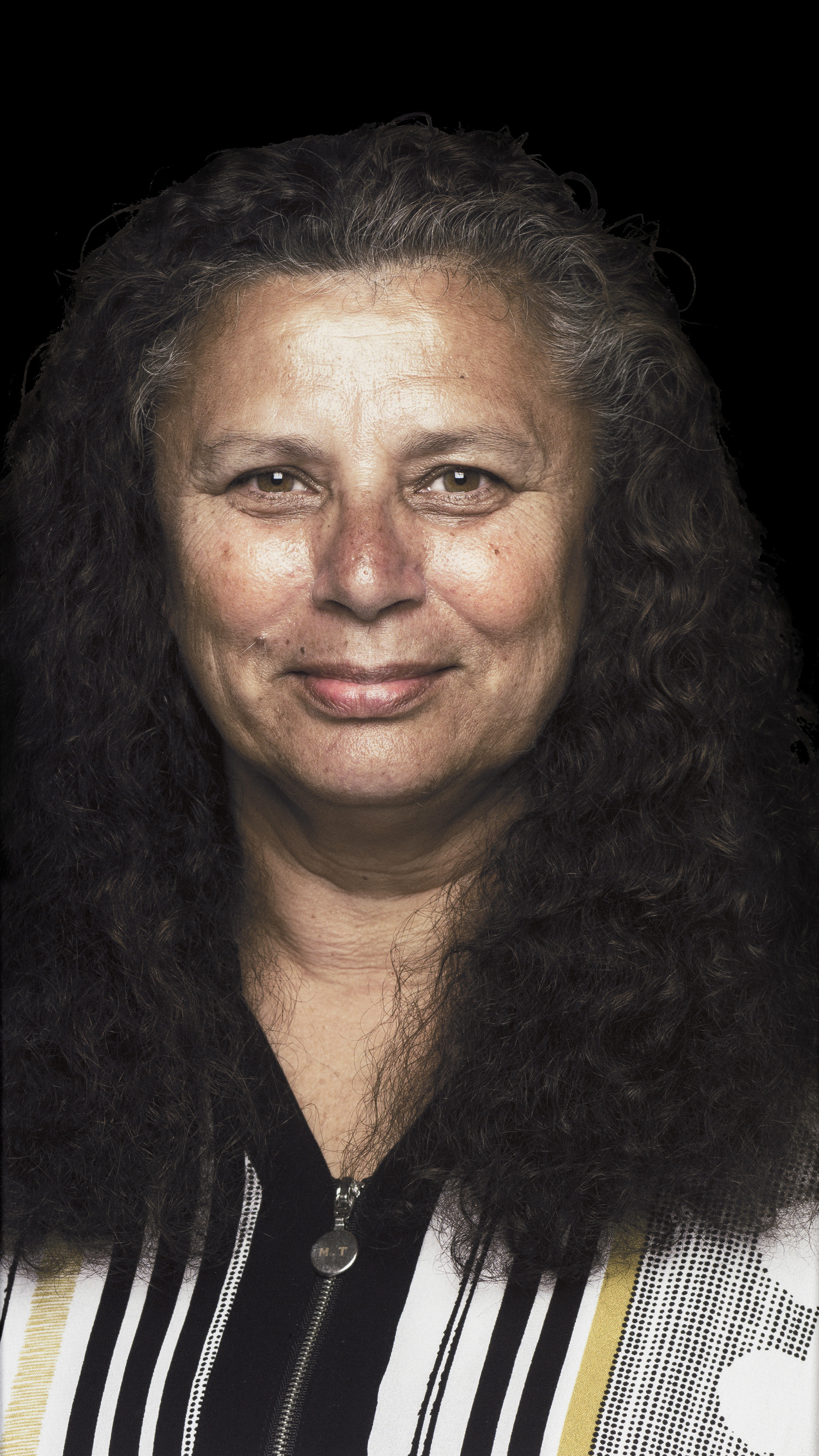 Contemporary photographic portrait of a smiling woman against a black backdrop