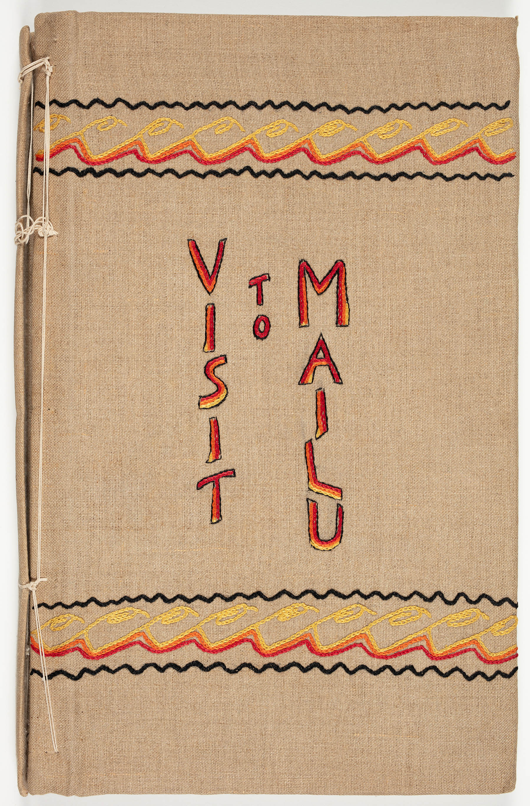 Embroidered diary cover reads 'Visit to Mailu'