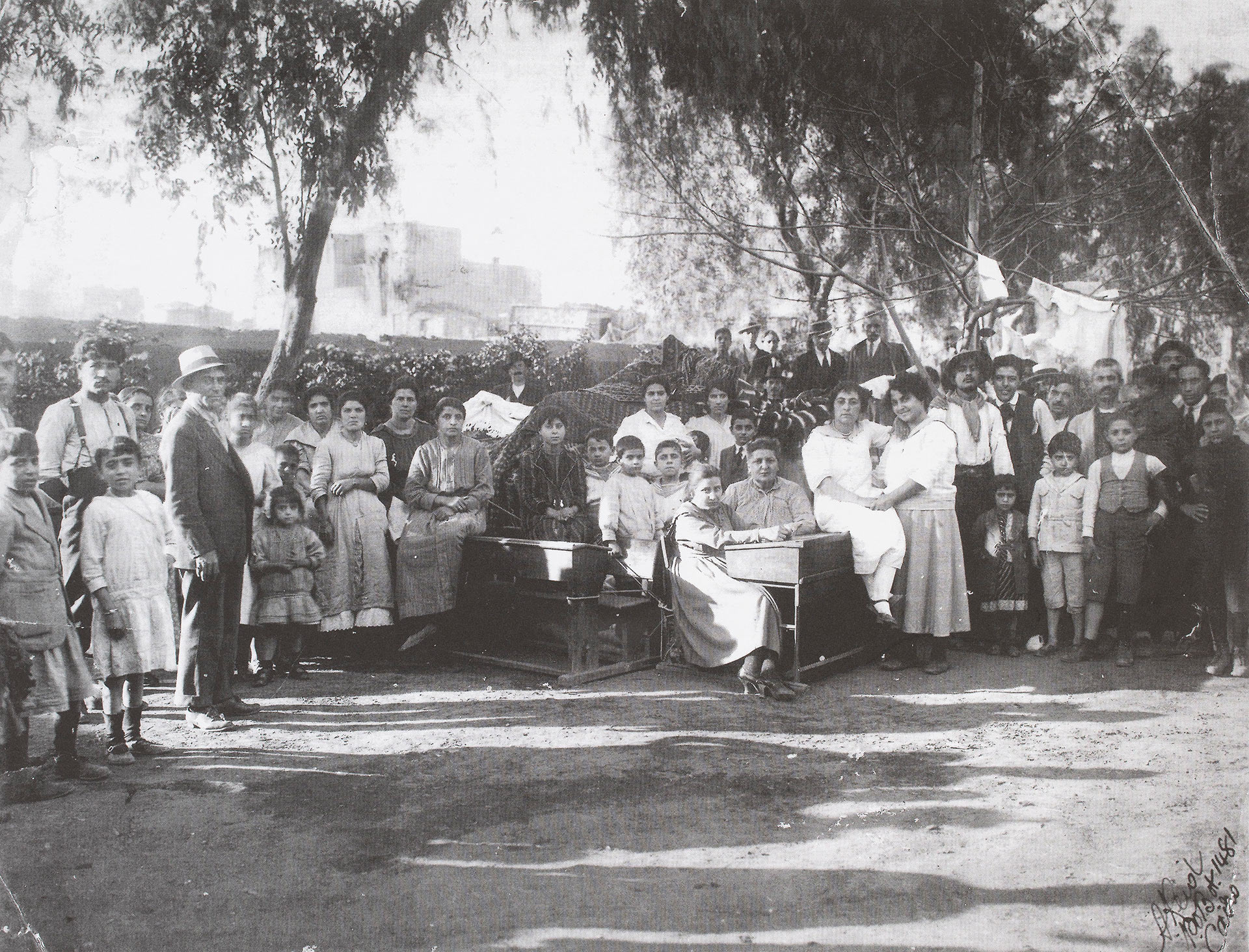 A group of 30 to 40 people outdoors, mostly children.