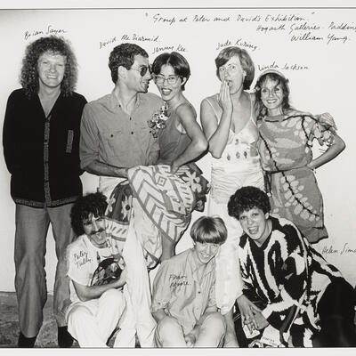 Black and white photo of a group of people standing together posing.