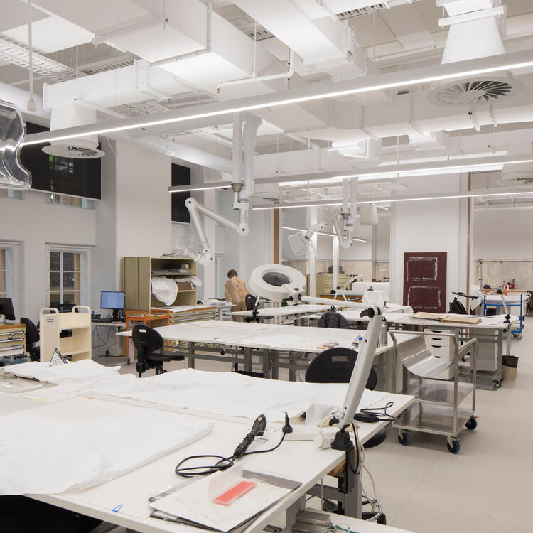 a room filled with tables and chairs and conservation technology and equipment