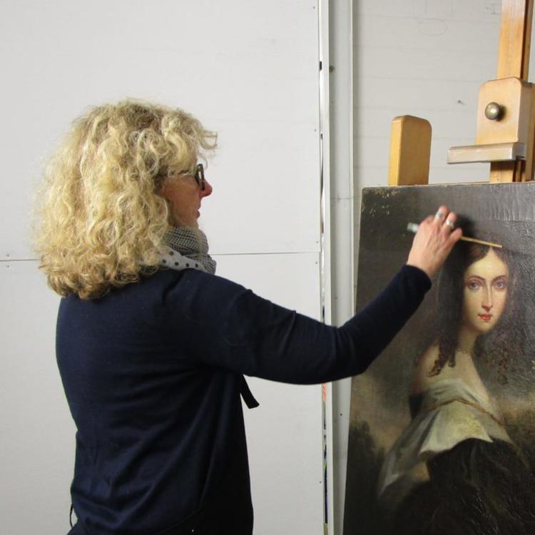 Julia Sharp, Conservation Manager, David Stein & Co, works on the painting 