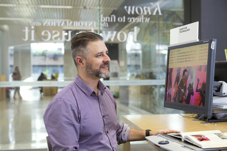 Person using Clearview to magnify book on the computer screen