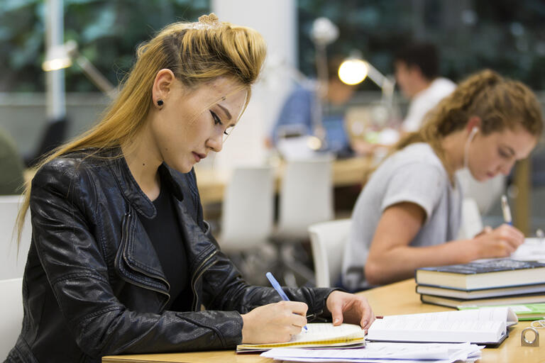 Two clients studying at a desk in the Governor Marie Bashir Reading Room