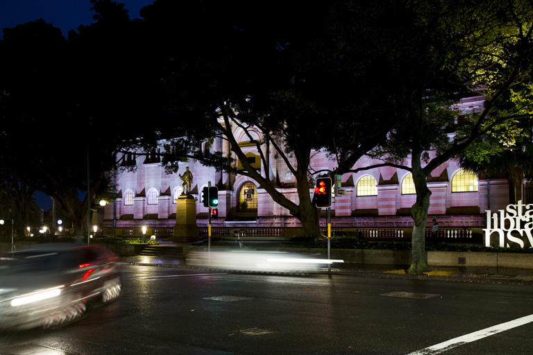 State Library NSW at night bathed in pink light