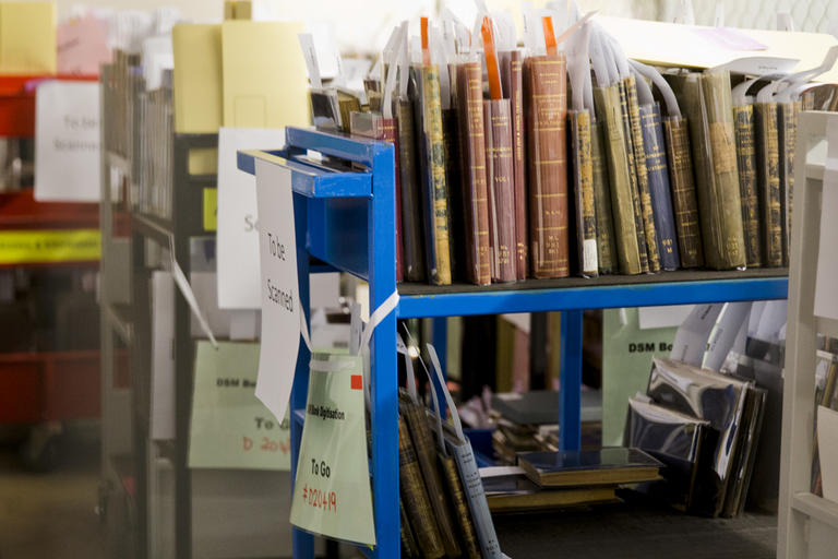 Trolleys with books covered in plastic