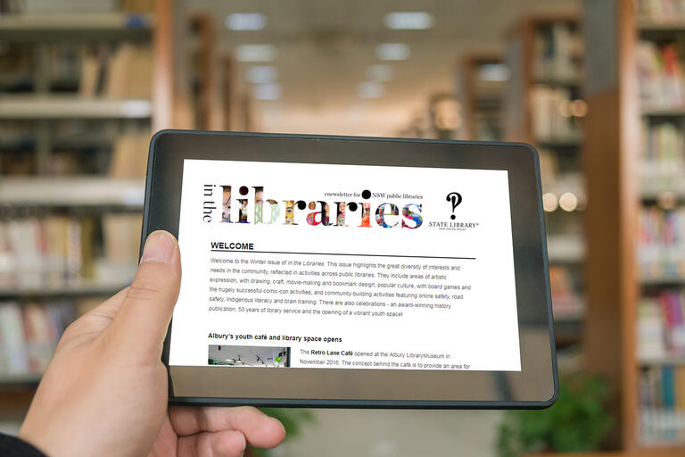 Newsletter screenshot on an ipad in a library