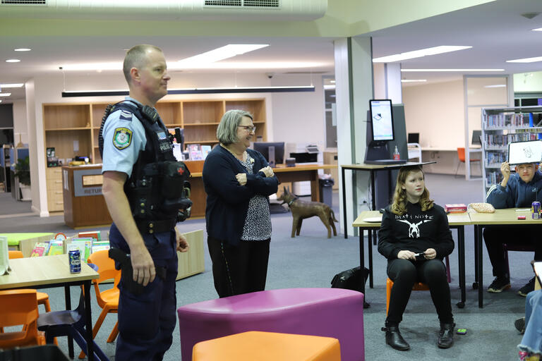 A police officer talking to a group of young people