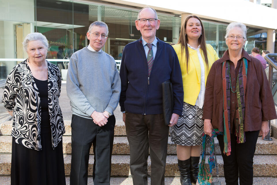 2 men and 3 women looking at the camera 