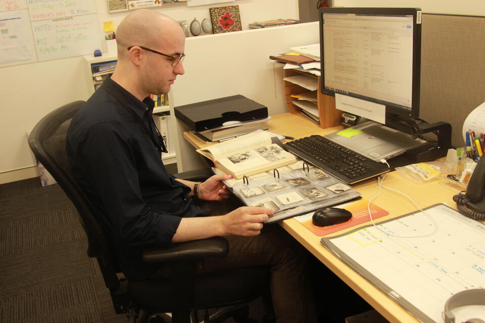 A man looking at a printed book