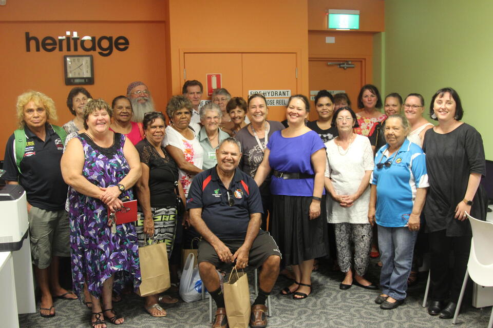 A group of people standing smiling